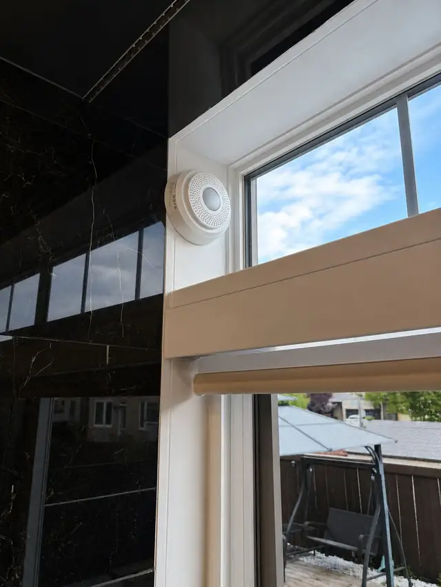 Alarm sensor installed at a window frame