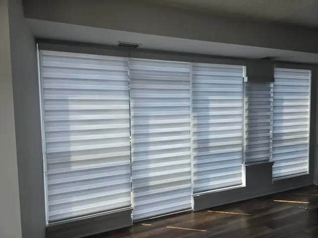 Zebra blinds across a wide window